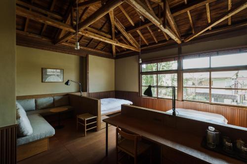 a hotel room with two beds and a couch at awai 戸隠 in Nagano