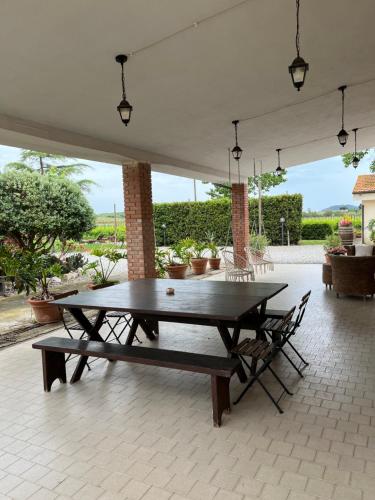 a ping pong table on a patio with two benches at Agriturismo Santa Lucia in Fonteblanda