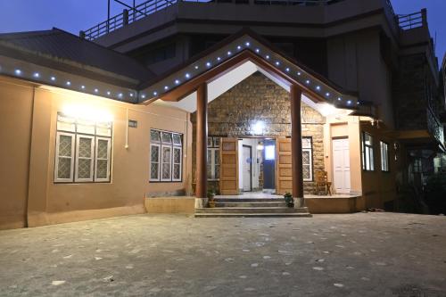 a house with a front porch with lights on it at The Living Roof in Shillong