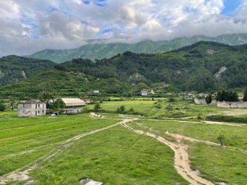 a grassy field with mountains in the background at Guest House Elisabeta in Përmet