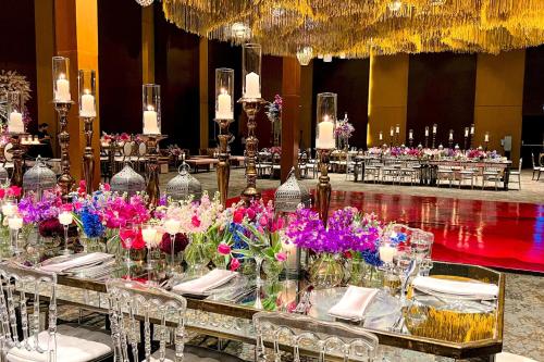 a dining room with tables with flowers on them at The Westin Camino Real, Guatemala in Guatemala