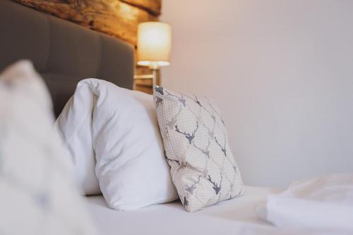 a bed with two pillows on top of it at Chalet Badia by we rent, SUMMERCARD INCLUDED in Zell am See