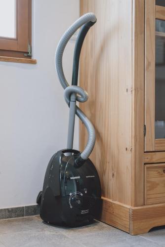 a vacuum sitting on the floor next to a wall at Chalet Badia by we rent, SUMMERCARD INCLUDED in Zell am See