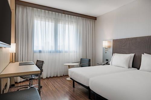 a hotel room with a large bed and a desk at AC Hotel Firenze by Marriott in Florence
