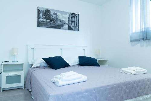 a bedroom with a bed with two towels on it at Central Moon Apartment no.1 in Split