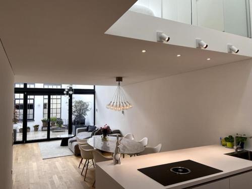 a kitchen and living room with a table and chairs at Bodensee Loft in Strandnähe in Lochau