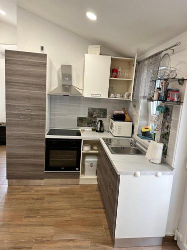 a kitchen with a stove and a counter top at Lora in Skradin