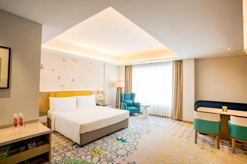 a hotel room with a bed and a desk at Holiday Inn Lucknow Airport by IHG in Lucknow