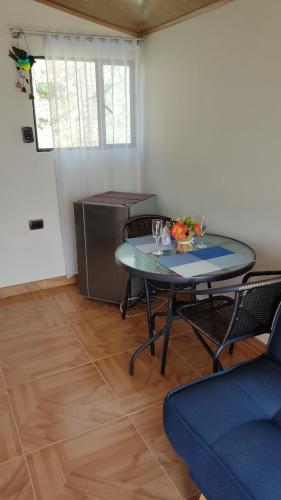 a dining room with a table and chairs in a room at Cabañas Villas Del Lago in Cuítiva
