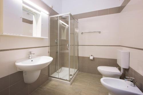 a bathroom with a sink and a toilet and a shower at Residence Barusso in Alassio