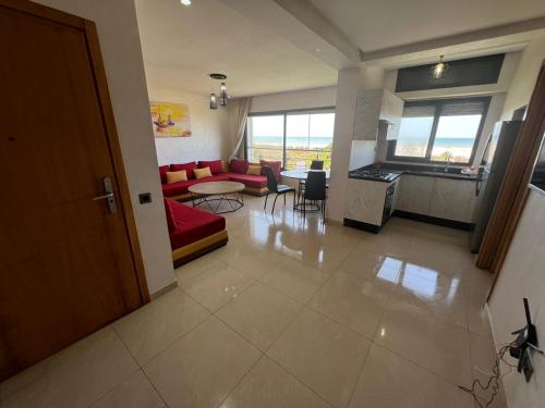 a living room with a couch and a table at CASA BEACH HOTEL in Sidi Rahal