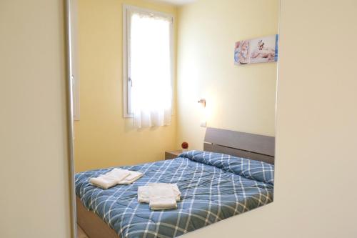 a bedroom with a bed with two towels on it at Agriturismo Da Rosy in Codevigo