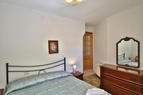a bedroom with a bed and a dresser and a mirror at Mamaamelia in Levanto