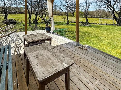 a wooden deck with two benches and a gazebo at 5 person holiday home in Brösarp-By Traum in Brösarp