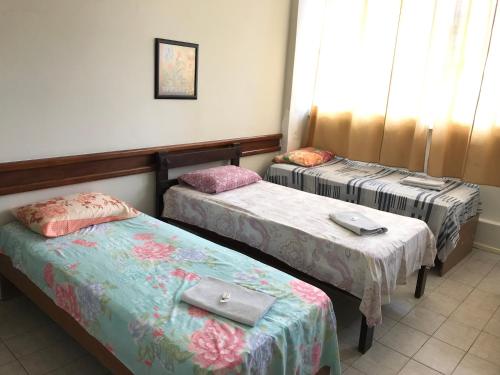 Una cama o camas en una habitación de Hotel Minas Salvador