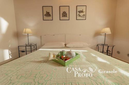 a bedroom with a bed with a tray of flowers on it at B&B Casa Probo in Tricase