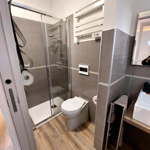 a bathroom with a toilet and a glass shower at B & B Eliana in Florence