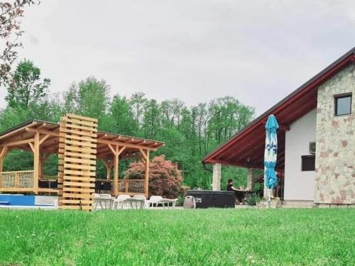 a pavilion with a table and chairs in a yard at Srce Kozare in Prijedor