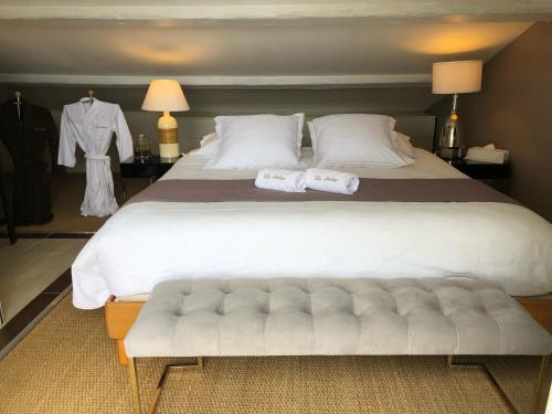 a large white bed with two towels on it at Villa Antoline in Cagnes-sur-Mer