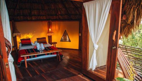 a bedroom with a bed and a table in a room at Ikal Tulum Hotel in Tulum