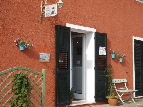 a building with a red door on the side of the building at B&B Il Gatto Pescatore in Stintino