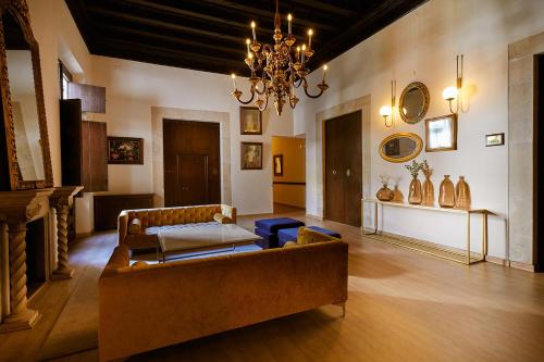 a living room with a couch and a chandelier at Hotel Born in Palma de Mallorca