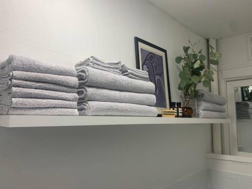 a pile of towels on a shelf in a bathroom at Crown Heights Charmer with private backyard access in Brooklyn