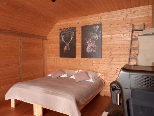 a bedroom with a bed in a wooden room at Susanna NEU mit Netflix in Bruchweiler