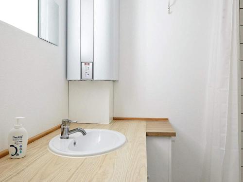 a bathroom with a white sink and a mirror at Holiday home Holbæk III in Holbæk