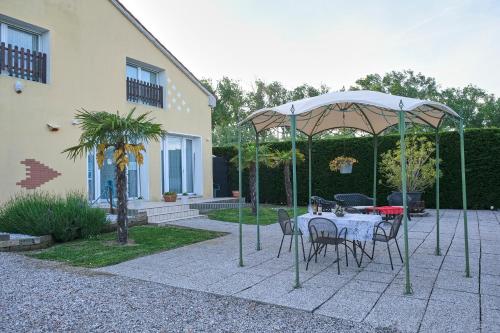 a patio with a table and chairs under an umbrella at Agriturismo Da Rosy in Codevigo