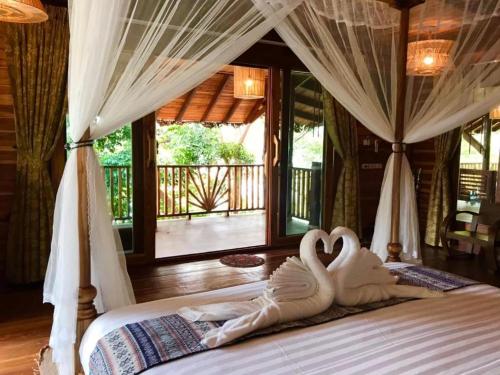 two swans carved into a bed in a bedroom at Viking Nature Resort in Phi Phi Islands