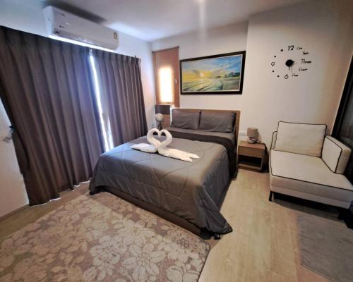 a hotel room with a bed and a chair at La Casita Hua Hin by Wilmot in Hua Hin