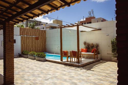 a patio with a pergola and a swimming pool at FLAT TOP COM 02 QUARTOS a 100m da ORLA de ATALAIA na TEMPORADA737 in Aracaju