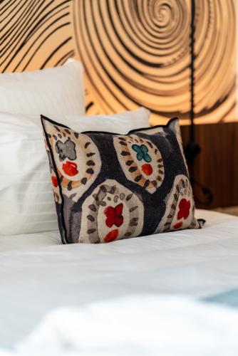 a pillow sitting on top of a bed at Hôtel Roz Marine Thalasso Resort in Perros-Guirec