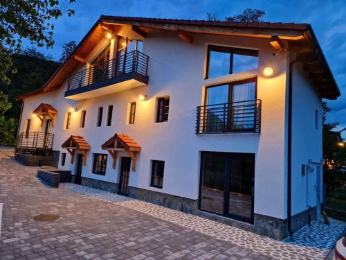 a white building with windows and balconies on it at RaHouse - Self Check-in & Free Parking in Braşov