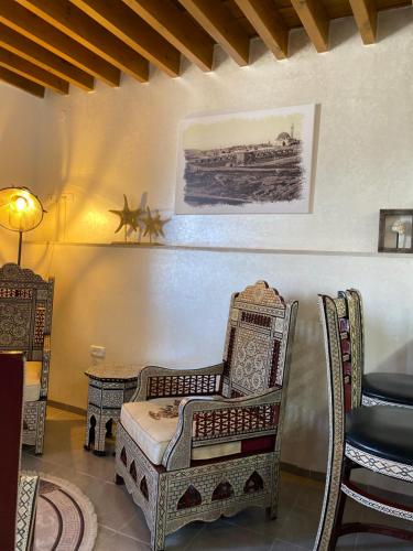 a living room with a chair and a table at Bab al-sham funduk in ‘Akko