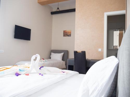 a bedroom with two beds with swans on them at Motel Rezime in Zenica