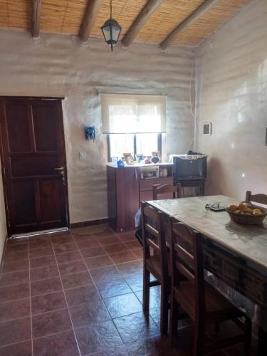 a kitchen with a table and chairs and a counter top at La calandria in Tilcara