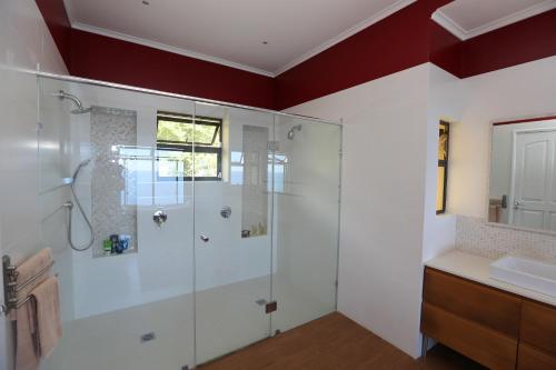 a bathroom with a shower and a sink at La Vue in Beau Vallon