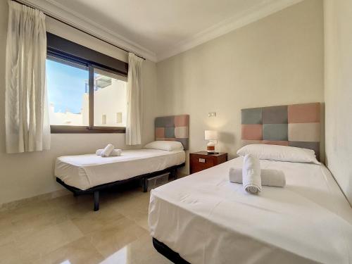 a room with two beds and a window at Roda Golf London Apartment - 9209 in San Javier