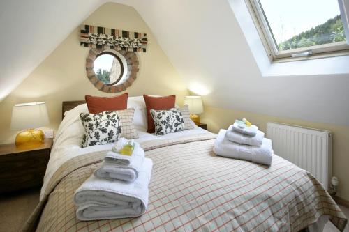 a bedroom with two beds in a attic at Stables in Little Dean