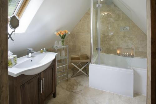 a bathroom with a sink and a shower at Stables in Little Dean