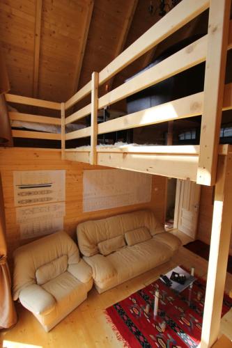 a living room with a couch under a loft bed at Weekend house Lokve - Modern in Berane