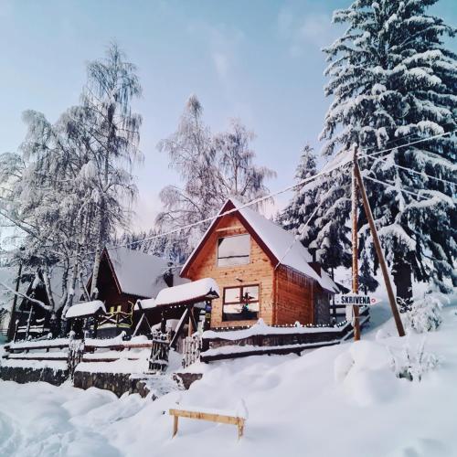 a log cabin with snow on the ground at Weekend house Lokve - Modern in Berane
