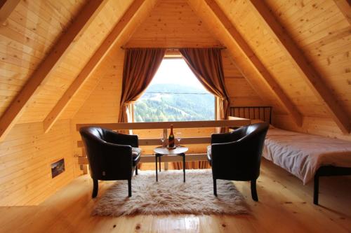 a bedroom with a bed and a table and chairs at Weekend house Lokve - Modern in Berane
