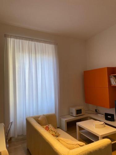 a living room with a couch and a table and a window at PALAZZO MARCHETTI in Ancona