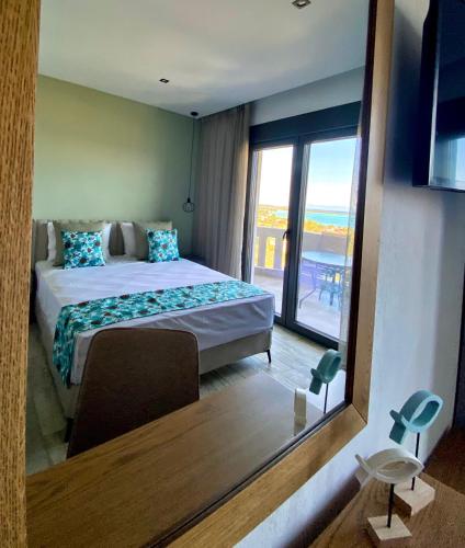 a bedroom with a bed and a large mirror at THEA Luxury Apartments in Vourvourou