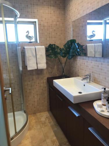 a bathroom with a sink and a toilet and a shower at Beachfront Apartment With Sea View in Azurara