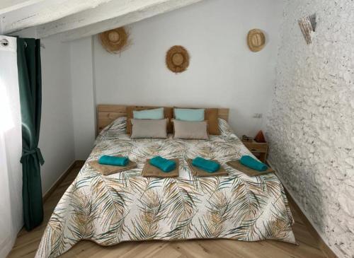 a bedroom with a bed with blue pillows at Loft B El Ramellet in Alginet