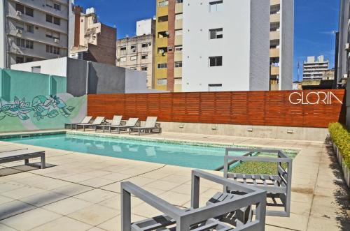 a swimming pool with lounge chairs in a city at CDM Temporal 2 in Rosario